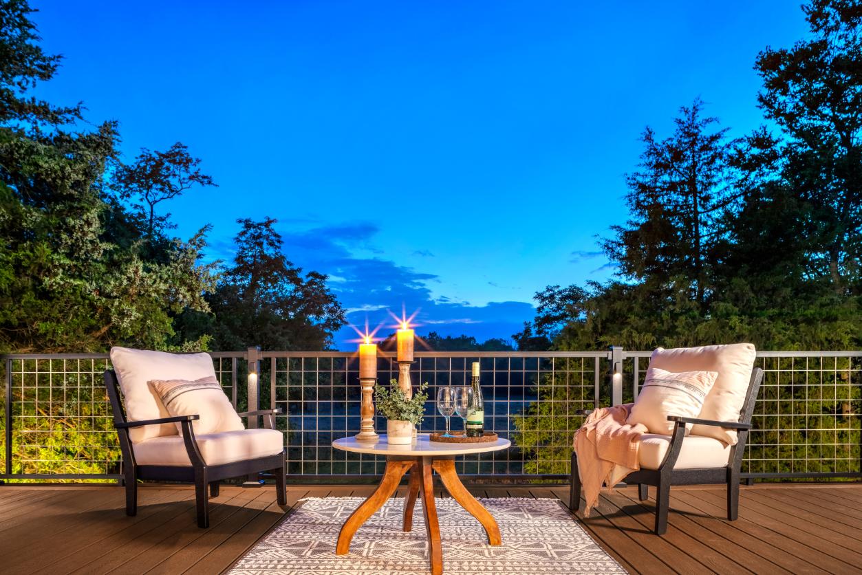 Outdoor setting at dusk candles on table with chairs